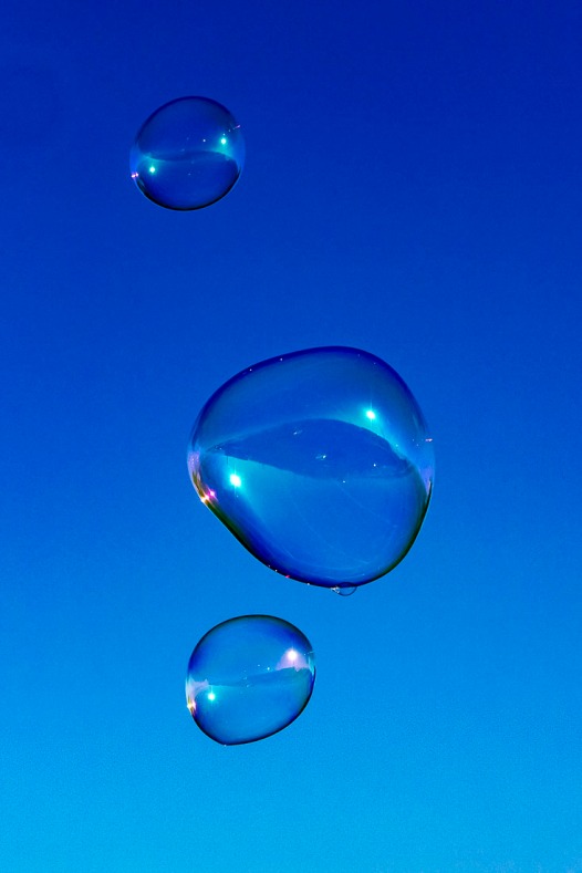 Giant bubbles against a blue morning sky.